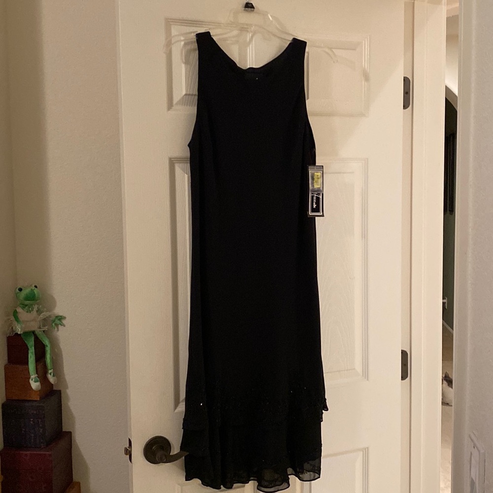 Sleeveless black dress. Three layers of beading  on the bottom. Size 6 .